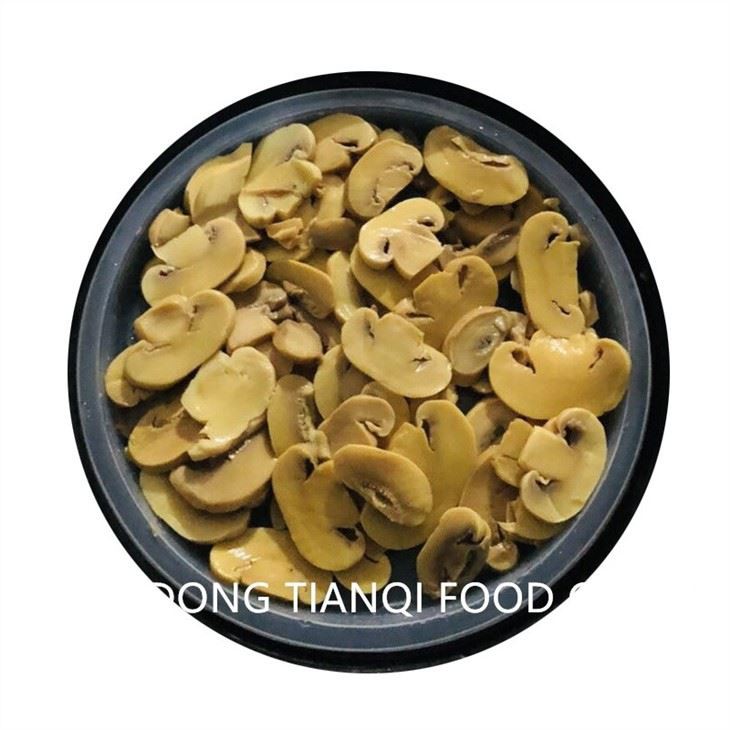 Sliced white mushroom in brine in drums